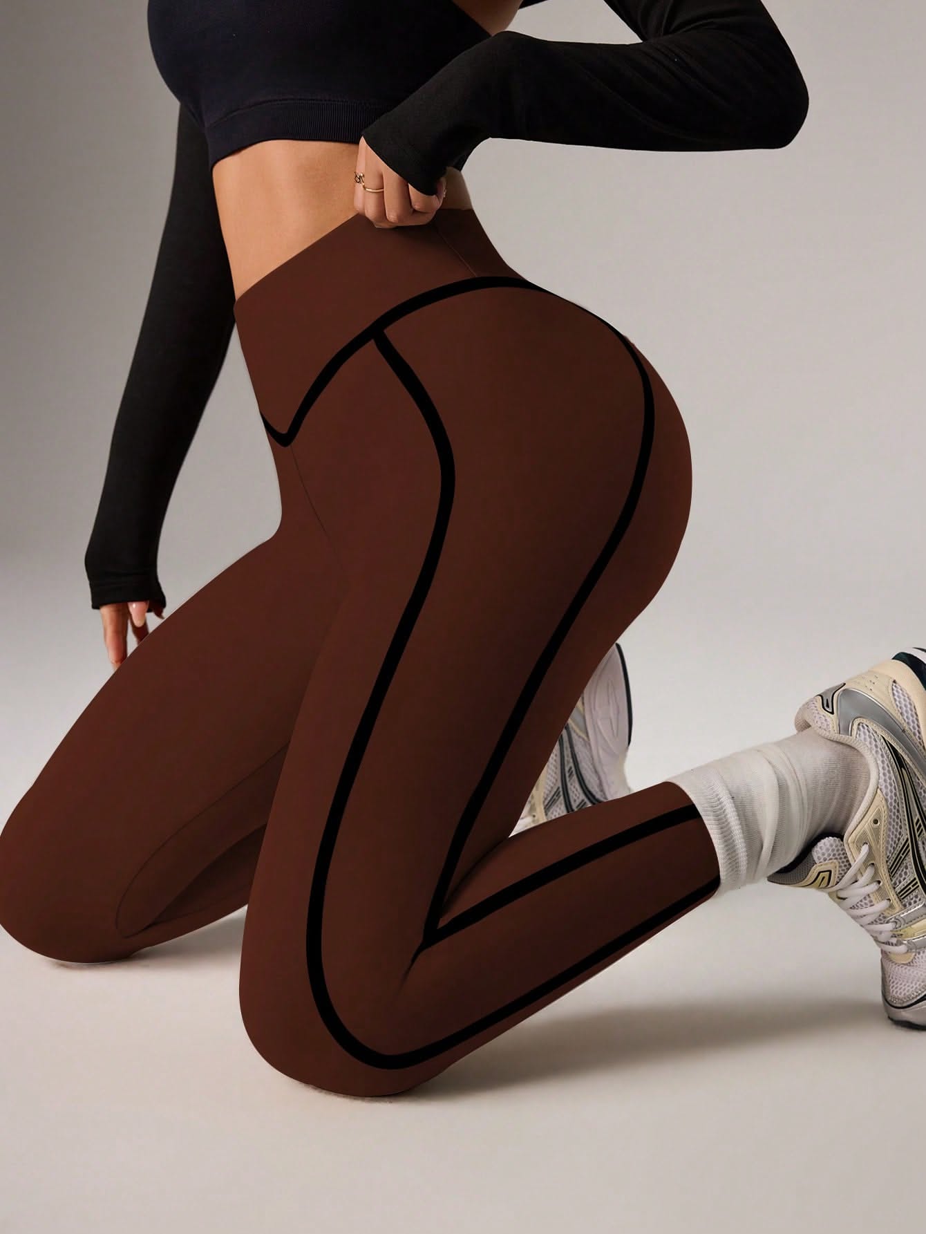 A Woman In Black Top And Brown Leggings Sitting On Creative Design Generator Genflow 模板預覽