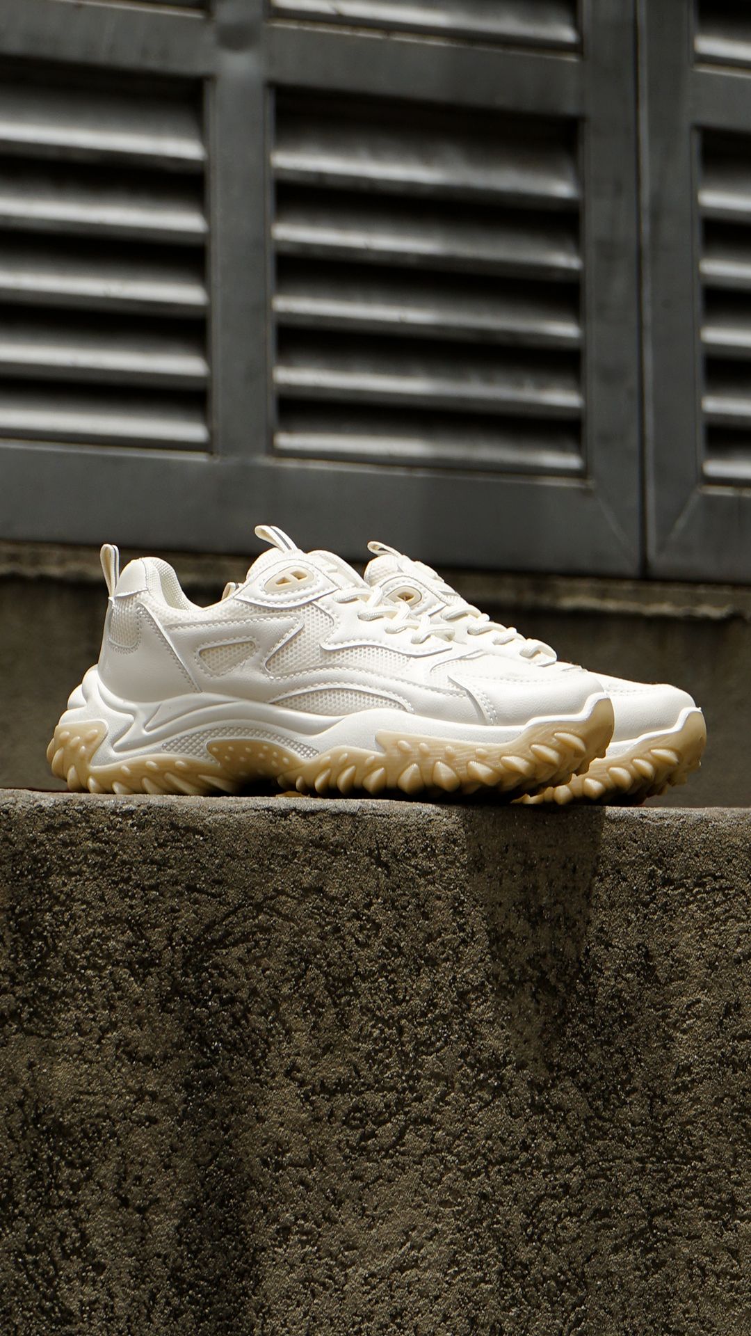 A Pair Of White Sneakers Sitting On Top Of A Cement Creative Design Generator Genflow テンプレートプレビュー