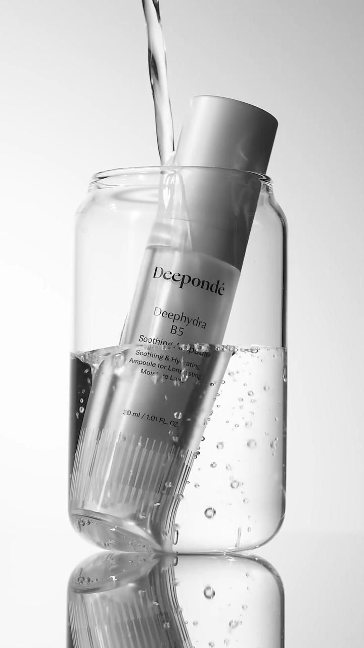 This May Contain: A Glass Filled With Water Next To A Bottle Creative Design Generator Genflow template preview