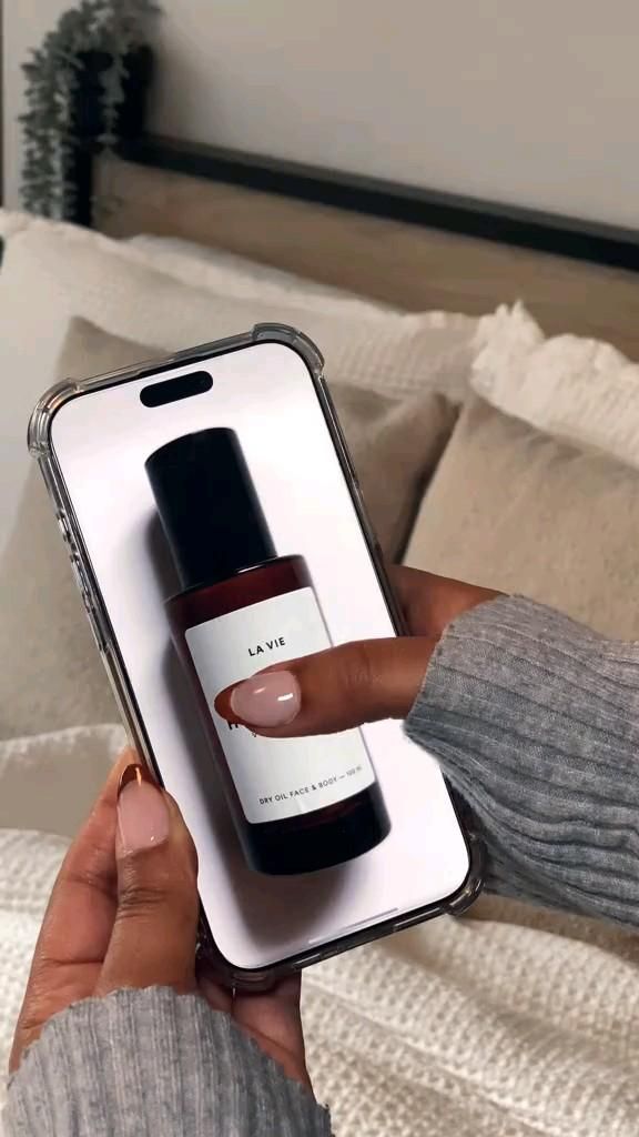 This May Contain: A Person Holding An Iphone In Their Hand With A Bottle Of Nail Polish On Creative Design Generator Genflow template preview
