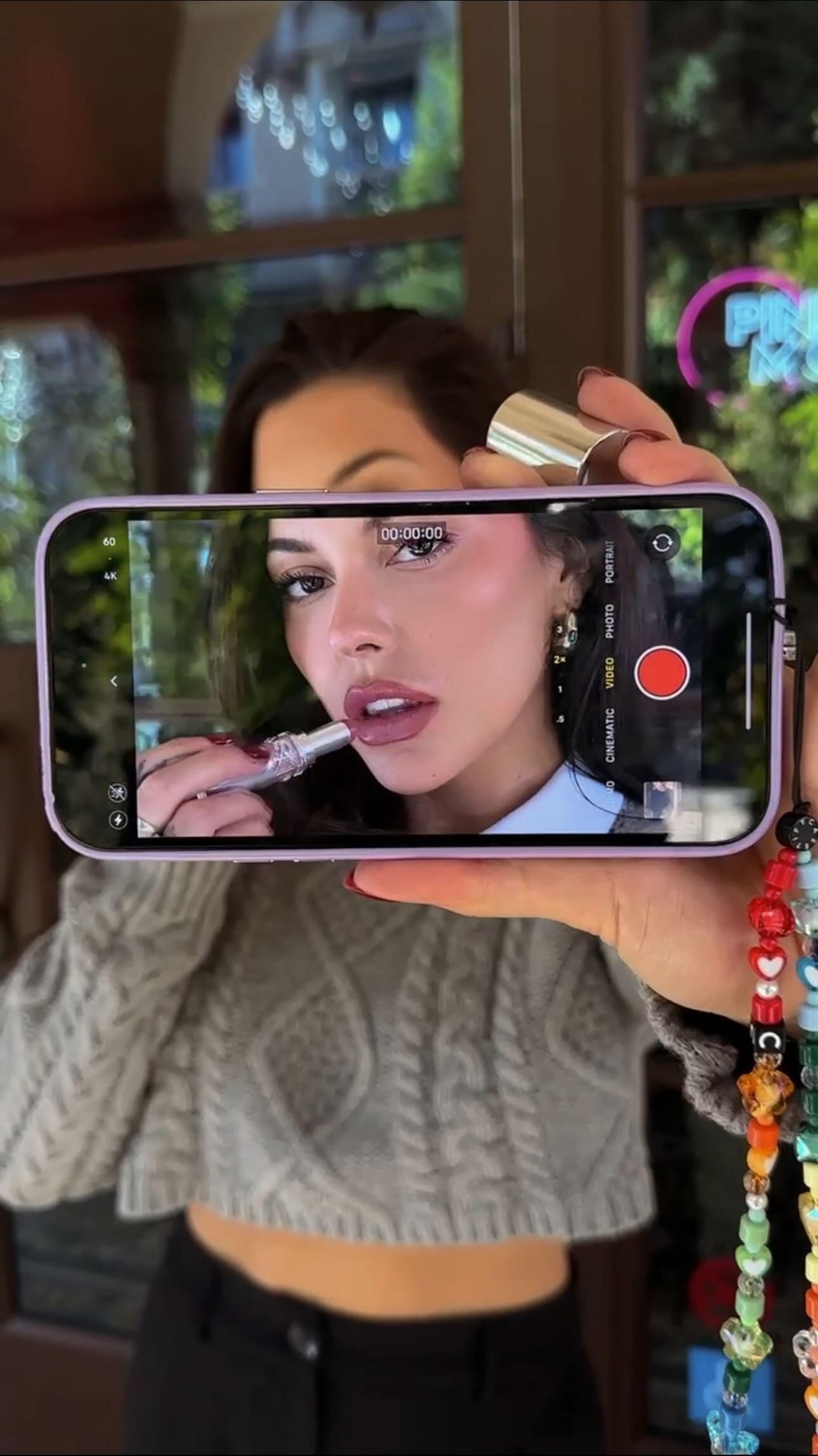 This May Contain: A Woman Taking A Selfie With Her Cell Phone And Necklaces Around Her Nec Creative Design Generator Genflow template preview