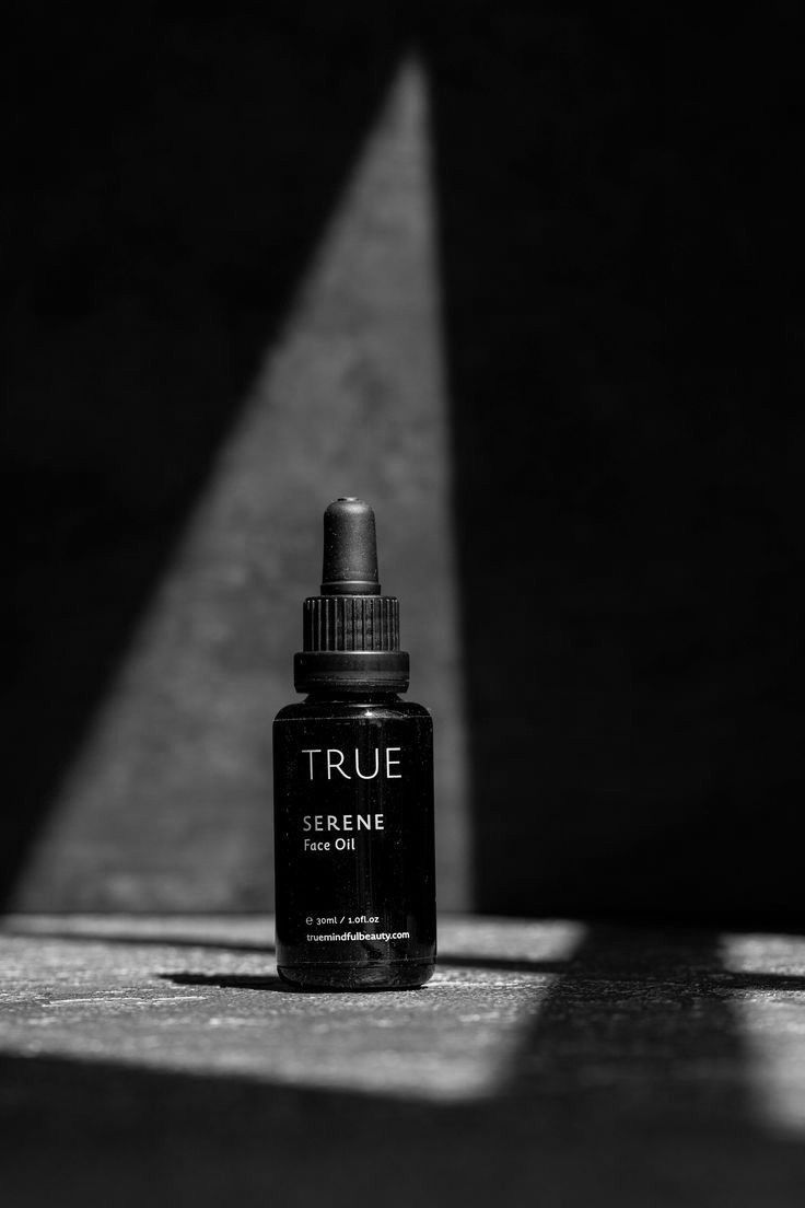 This May Contain: A Black And White Photo Of A Bottle Of True Skinceine On The Ground Creative Design Generator Genflow template preview