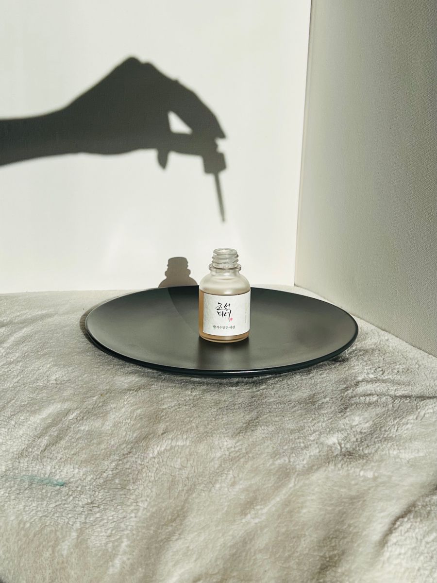 This May Contain: A Person's Shadow Is Cast On The Wall Next To A Bottle Creative Design Generator Genflow template preview
