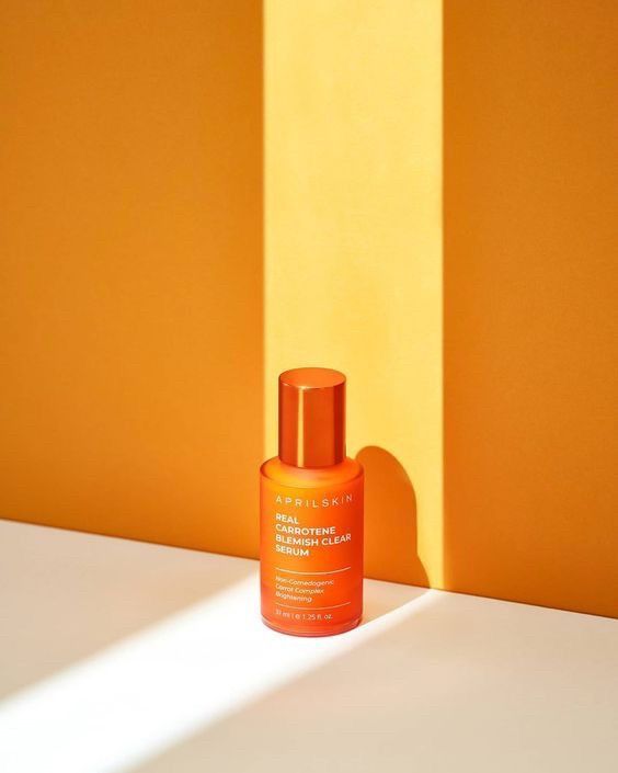 This May Contain: An Orange Bottle Sitting On Top Of A White Counter Next To A Yellow And Creative Design Generator Genflow template preview