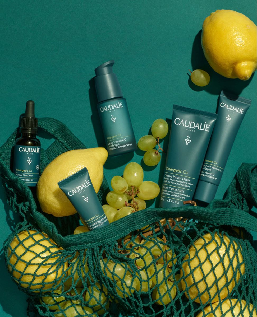 This May Contain: The Contents Of A Green Bag With Yellow Grapes And Lemons In It, Along W Creative Design Generator Genflow 模板预览