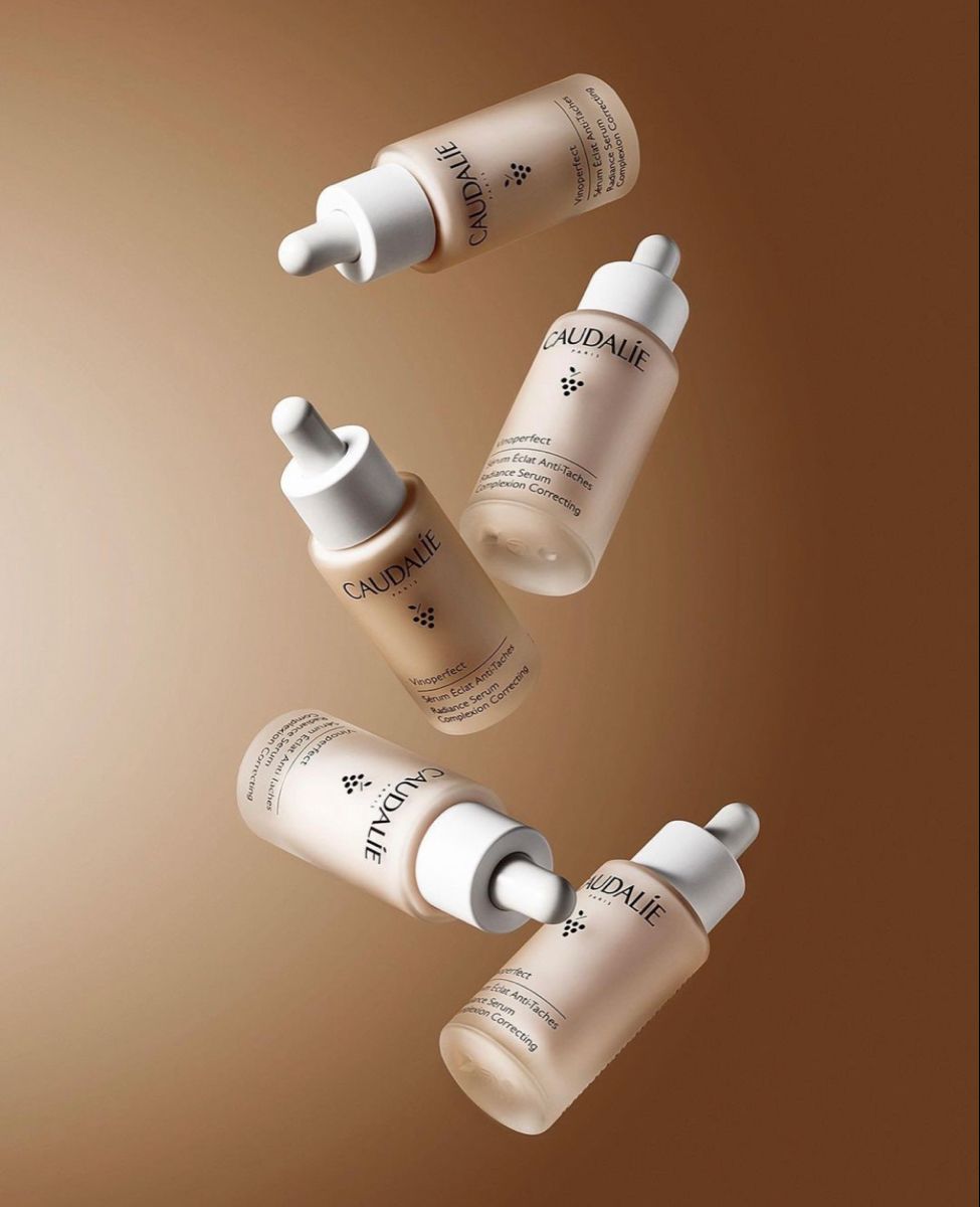 Three Bottles Of Skin Care Are Flying Through The Air In Front Of A Brown Background Creative Design Generator Genflow template preview