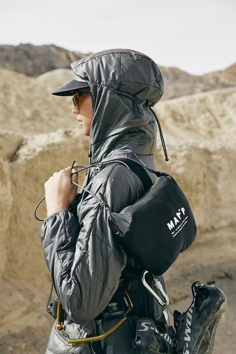 A Man In Grey Jacket And Black Hat With Backpack On His Back Walking Through The Desert Creative Design Generator Genflow 模板預覽