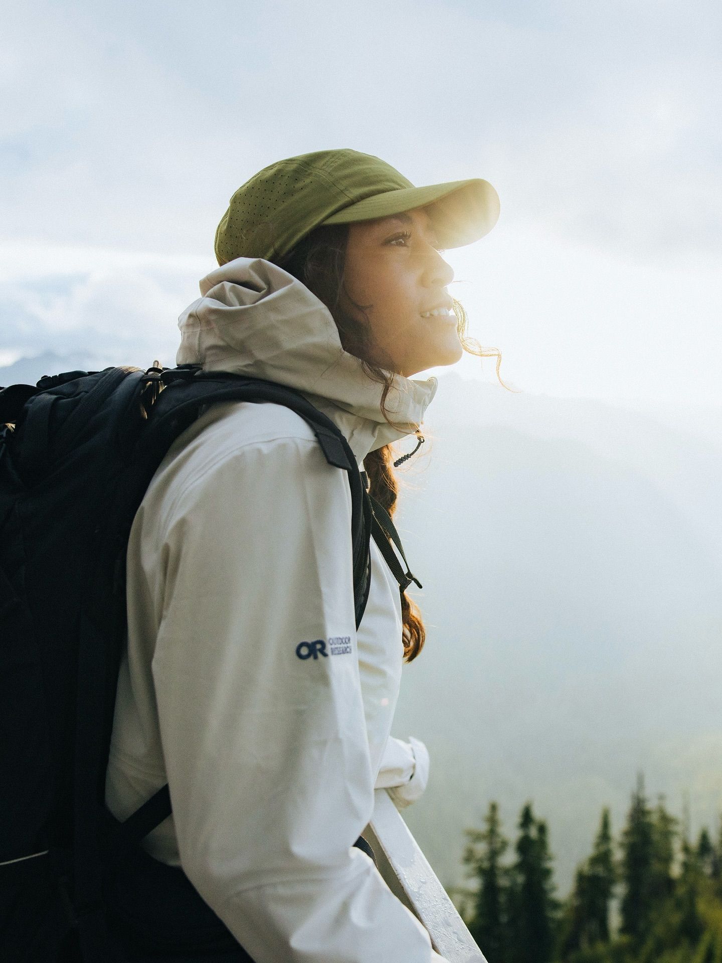 A Woman With A Backpack And Hat Looking Up At The Sky While Standing On Top Of A Mountain Creative Design Generator Genflow template preview