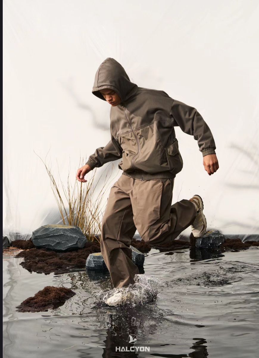 A Man Is Jumping In The Water Wearing A Hoodie And Running Through Some Rocks Creative Design Generator Genflow テンプレートプレビュー