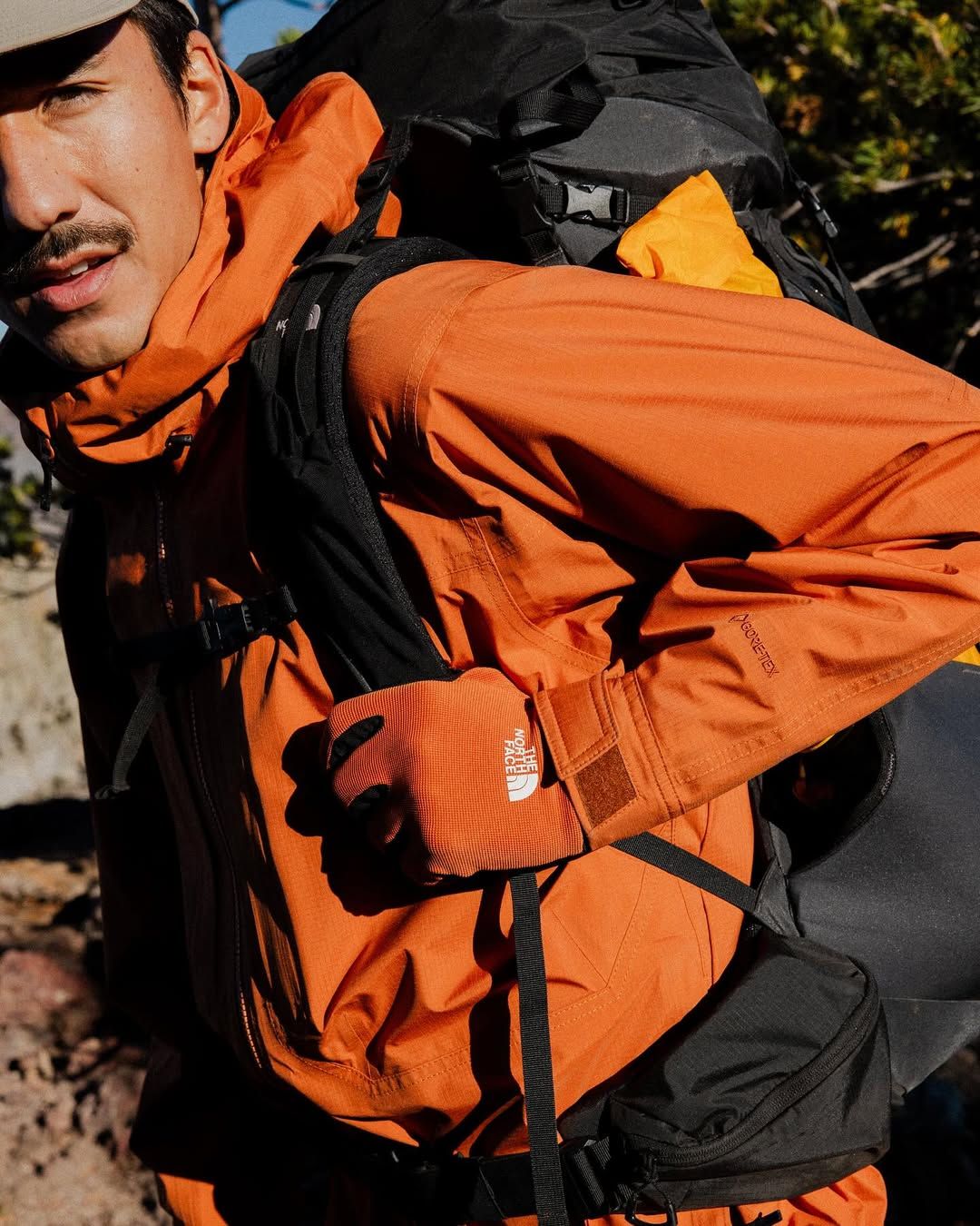 A Man In An Orange Jacket Carrying A Backpack Creative Design Generator Genflow 模板預覽