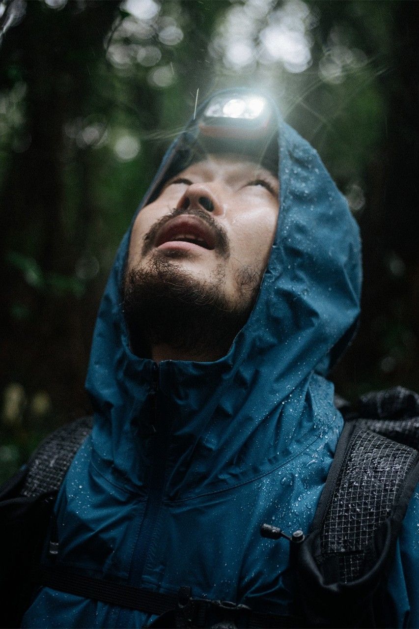 A Man Wearing A Blue Jacket With A Flashlight On His Head In The Woods, Looking Up Creative Design Generator Genflow 模板预览